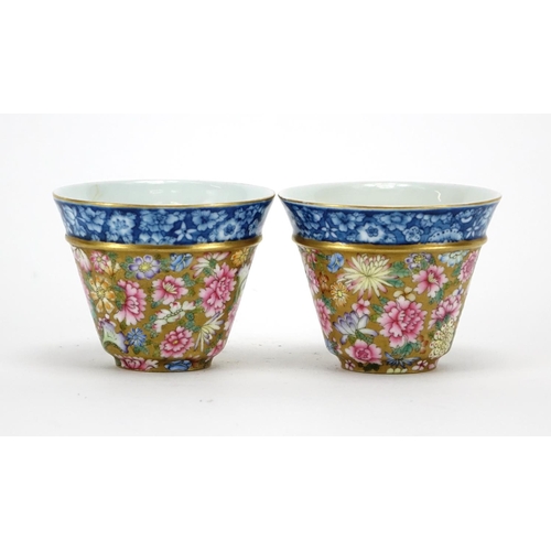 285 - Pair of Chinese porcelain tea cups, each finely hand painted in the famille rose palette with flower... 