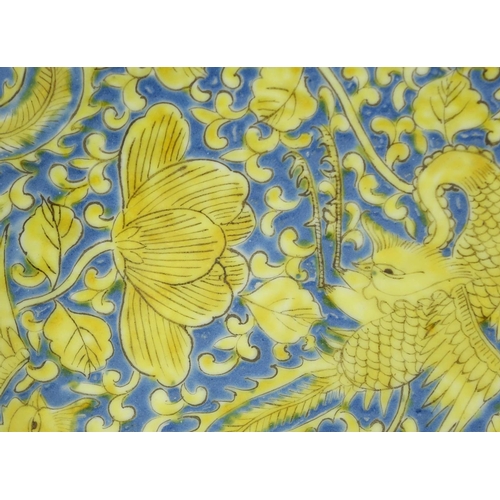 294 - Chinese porcelain shallow dish, hand painted in yellow with six phoenixes amongst flowers onto a blu... 