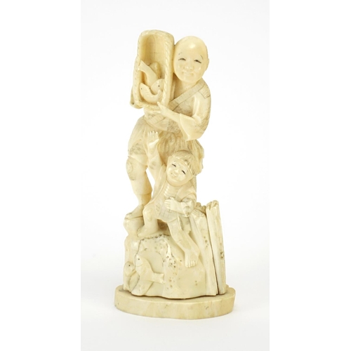 410 - Japanese carved ivory okimono of a fisherman and young boy, 18cm high