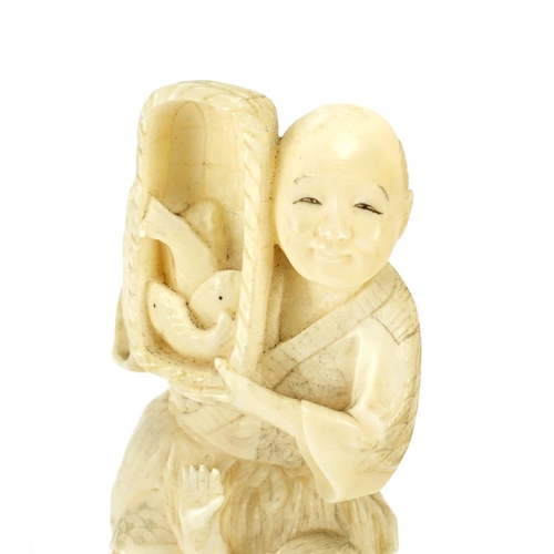 410 - Japanese carved ivory okimono of a fisherman and young boy, 18cm high