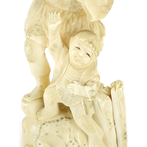 410 - Japanese carved ivory okimono of a fisherman and young boy, 18cm high