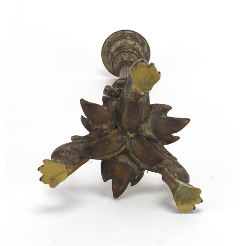16 - 19th century patinated bronze candlestick with paw feet, the column decorated in relief with a lizar... 