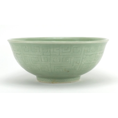 340 - Chinese celadon glazed footed bowl incised with a geometric repeat design, 26.5cm in diameter