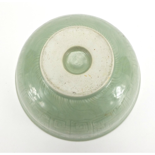 340 - Chinese celadon glazed footed bowl incised with a geometric repeat design, 26.5cm in diameter