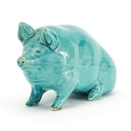 504 - Turquoise glazed pottery pig in the style of Wemyss, 10cm high
