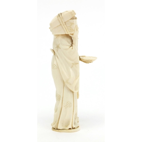 407 - Japanese carved ivory okimono of an elder holding a box, character marks to the base, 12.5cm high