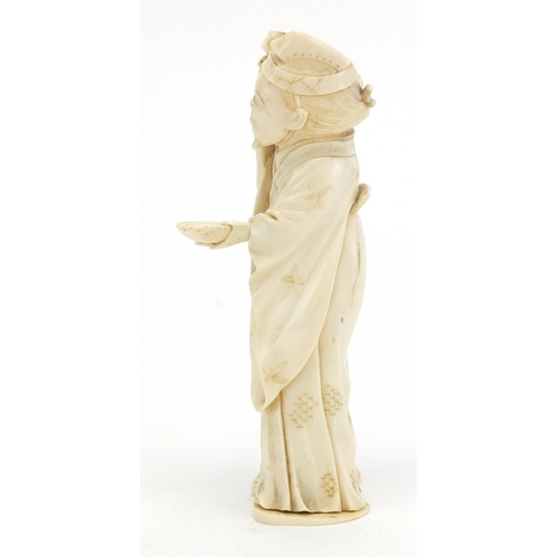 407 - Japanese carved ivory okimono of an elder holding a box, character marks to the base, 12.5cm high