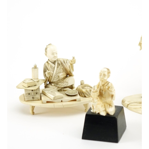 406 - Japanese carved ivory okimono's including a man holding a fan and a fisherman, some with character m... 