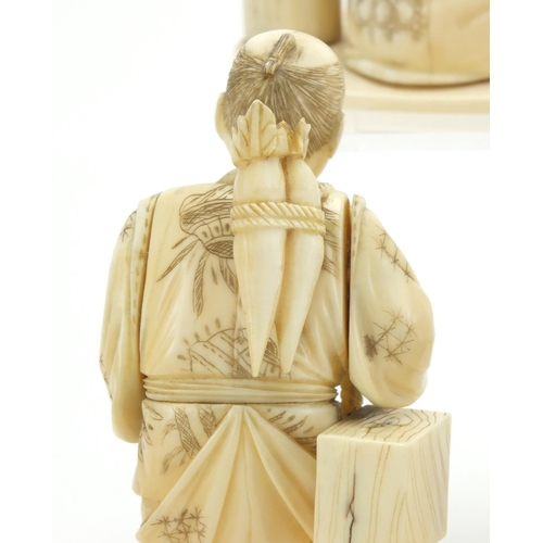 406 - Japanese carved ivory okimono's including a man holding a fan and a fisherman, some with character m... 