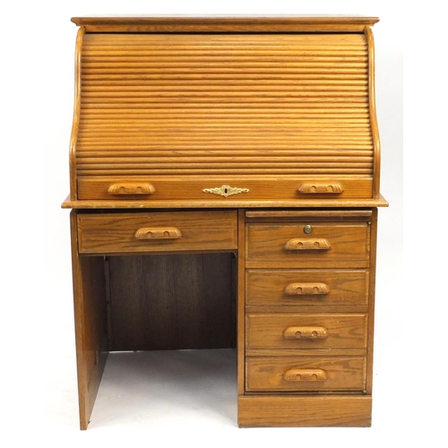 12 - Oak Tambour front desk, fitted with five drawers, 132cm H x 103cm W x 73cm D