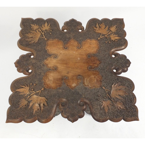 2035 - Anglo Indian hardwood folding table, profusely carved with fruiting leaves, 62cm H x 72cm W x 72cm D