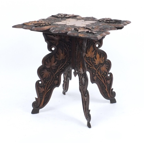 2039 - Anglo Indian folding table profusely carved with fruiting leaves, 62cm H x 60cm W x 60cm D