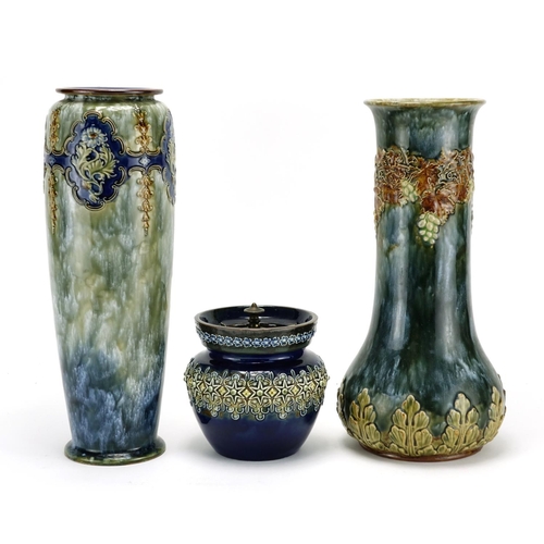 530 - Two Art Nouveau Royal Doulton vases and a Doulton Lambeth tobacco jar decorated in relief with flowe... 