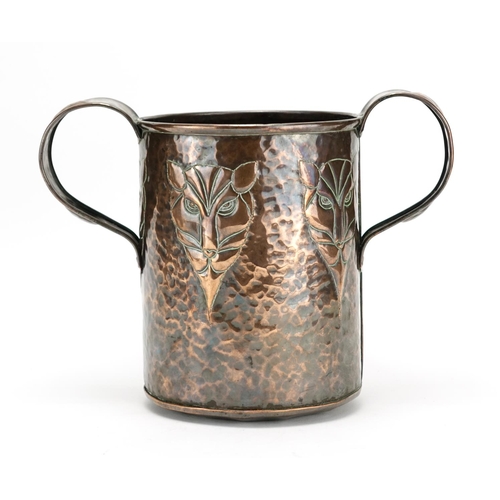 574 - Arts & Crafts copper loving cup embossed with five stylised lions heads, 20.5cm high