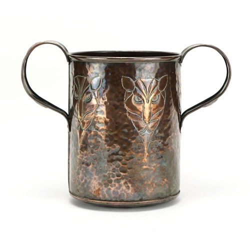 574 - Arts & Crafts copper loving cup embossed with five stylised lions heads, 20.5cm high