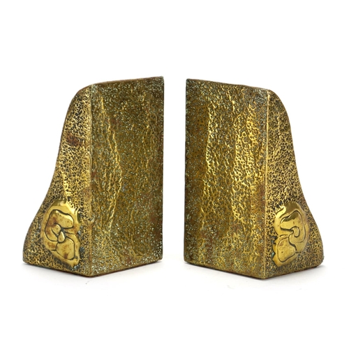 585 - Pair of Scottish school Arts & Crafts brass bookends, each embossed with stylised a bird, each 15.5c... 