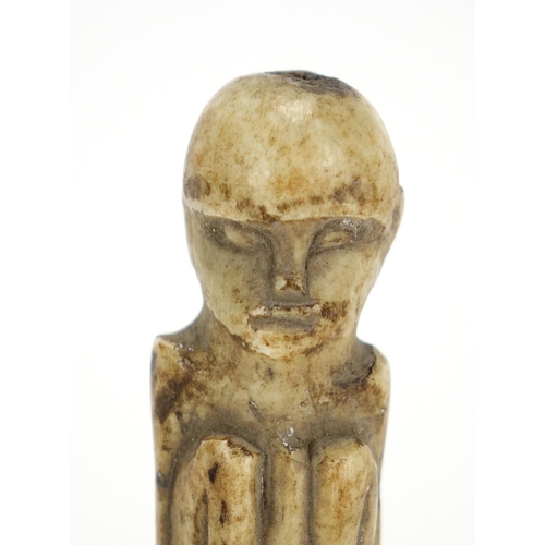 469 - Tribal interest bone carving raised on a later square perspex base, 7cm high