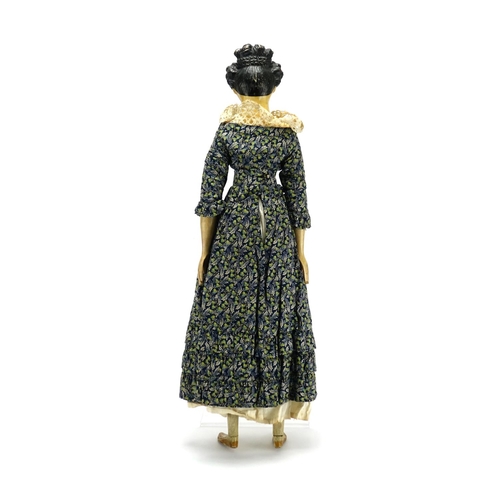131 - Early 19th century German Papier-mâché doll with wooden limbs in traditional dress, with Antiques Ro... 