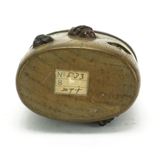 368 - Japanese oval wooden inro with carved ivory Ojime, the inro having applied Noh masks, 8cm high