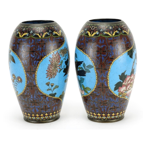 374 - Pair of Japanese cloisonné vases raised on hardwood stands, each enamelled with birds of paradise an... 