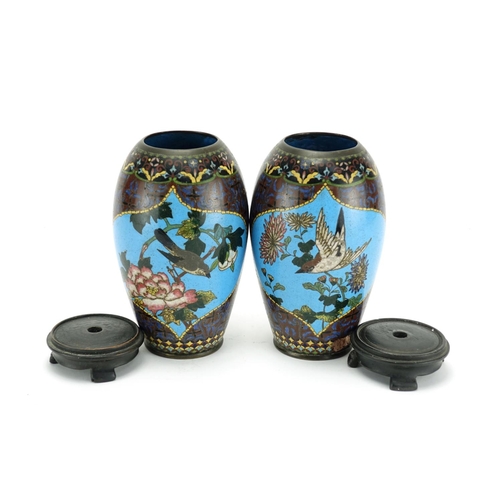 374 - Pair of Japanese cloisonné vases raised on hardwood stands, each enamelled with birds of paradise an... 