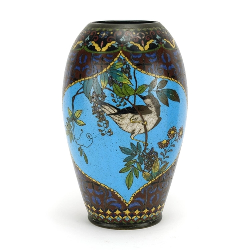 374 - Pair of Japanese cloisonné vases raised on hardwood stands, each enamelled with birds of paradise an... 