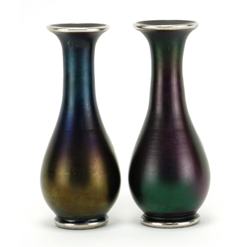 521 - Pair of Art Nouveau iridescent glass vases in the style of Loetz with silver floral inlay, each 15cm... 
