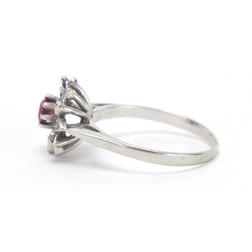 727 - 18ct white gold ruby and diamond flower head ring, size O, approximate weight 3.2g