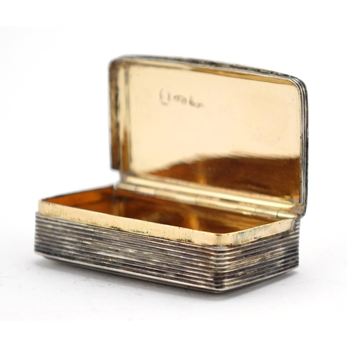 614 - Georgian silver snuff box, the hinged lid with floral chased decoration and gilt interior, Birmingha... 