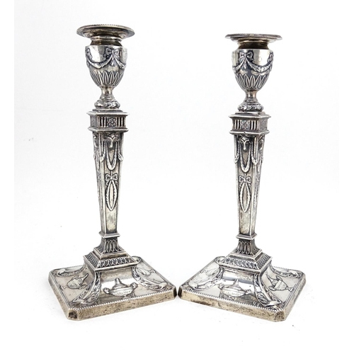 602 - Pair of Adam's style square based candlesticks with tapering columns, embossed with swags and rams h... 