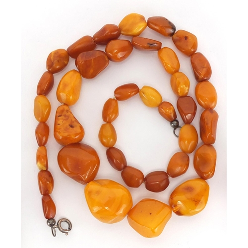 804 - Butterscotch amber coloured bead necklace, silver mounted earrings and pendant, approximate weight 4... 