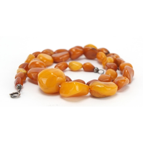 804 - Butterscotch amber coloured bead necklace, silver mounted earrings and pendant, approximate weight 4... 