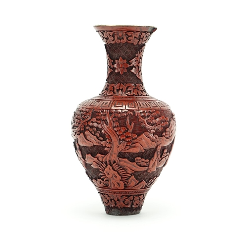 382 - Chinese cinnabar lacquer vase carved with figures in a landscape, 21.5cm high