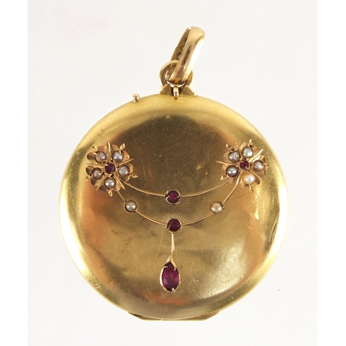 758 - Victorian unmarked gold ruby and seed pearl locket, 3cm in diameter, approximate weight 6.1g