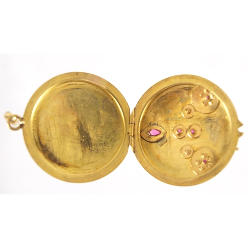 758 - Victorian unmarked gold ruby and seed pearl locket, 3cm in diameter, approximate weight 6.1g