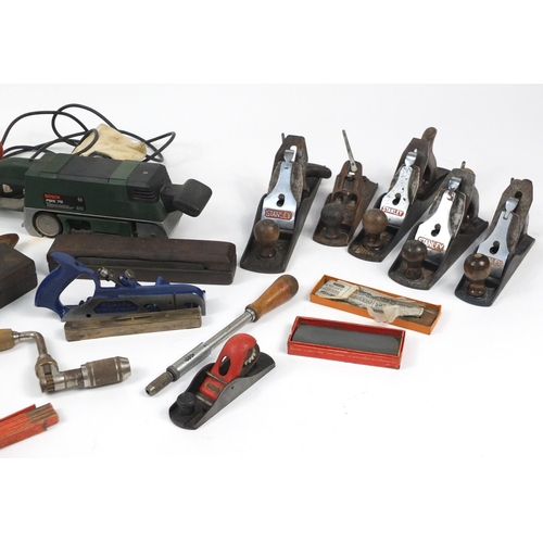 102 - Vintage tools including Stanley wood planes and Black & Decker belt sander