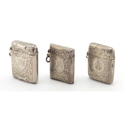 625 - Three rectangular silver vesta's with engraved floral decoration, Birmingham and Chester hallmarks, ... 