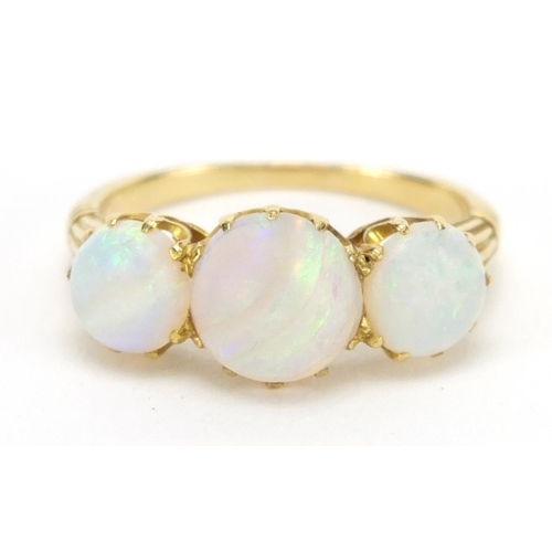 731 - Unmarked gold cabochon opal three stone ring, size O, approximate weight 3.9g