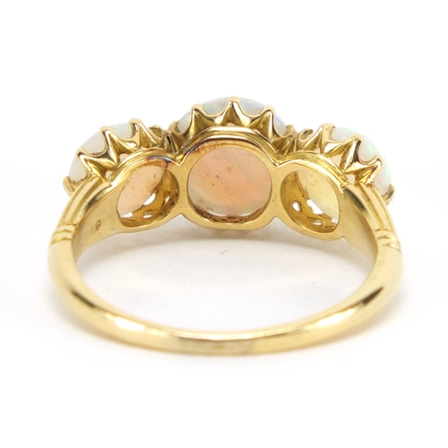 731 - Unmarked gold cabochon opal three stone ring, size O, approximate weight 3.9g