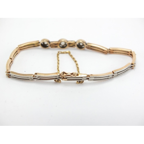 707 - Art Deco two tone unmarked gold diamond bracelet, 16cm in length, approximate weight 11.2g