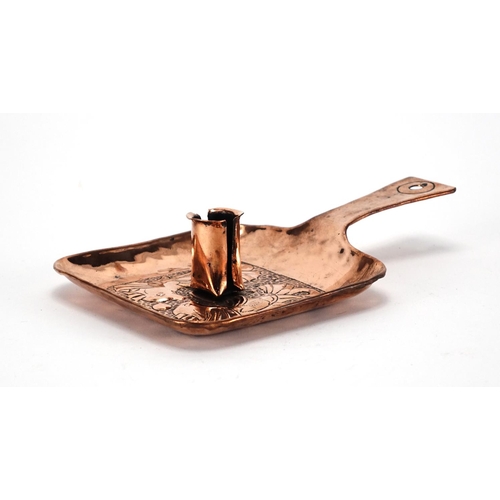 570 - Arts & Crafts Newlyn school copper chamber stick, embossed with two stylised fish, 22cm in length