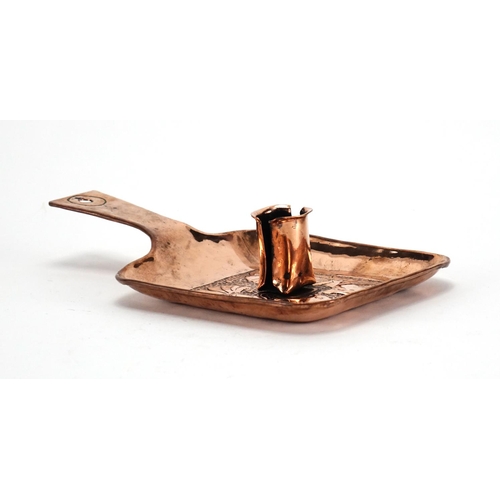 570 - Arts & Crafts Newlyn school copper chamber stick, embossed with two stylised fish, 22cm in length