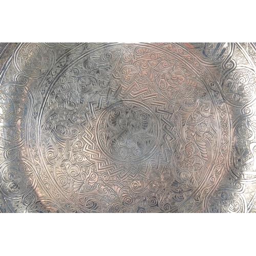 451 - Islamic unmarked silver dish, engraved with script and foliate motifs, 23cm in diameter, approximate... 