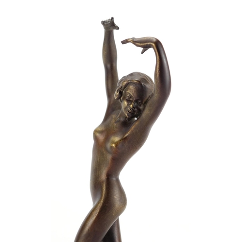 567 - Patinated bronze study of a nude Art Deco female raised on a green onyx base, 25cm high