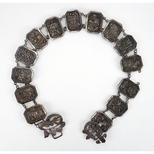 386 - Chinese silver belt, the rectangular panels with canted corners embossed with dragons and flowers, 7... 