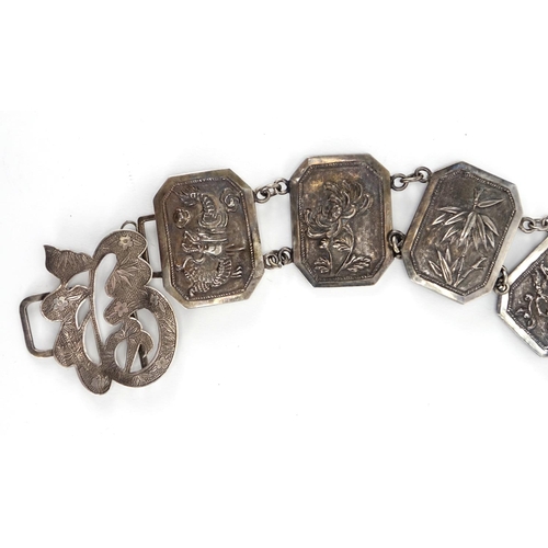 386 - Chinese silver belt, the rectangular panels with canted corners embossed with dragons and flowers, 7... 