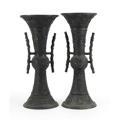 358 - Pair of Japanese bronze vases with tin handles, cast with mythical animals, each 36.5cm high