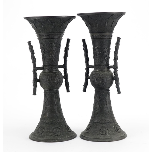 358 - Pair of Japanese bronze vases with tin handles, cast with mythical animals, each 36.5cm high