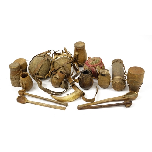 473 - Tribal woodenware including spoons, drums and water carriers with cowry shells, the largest 52cm in ... 