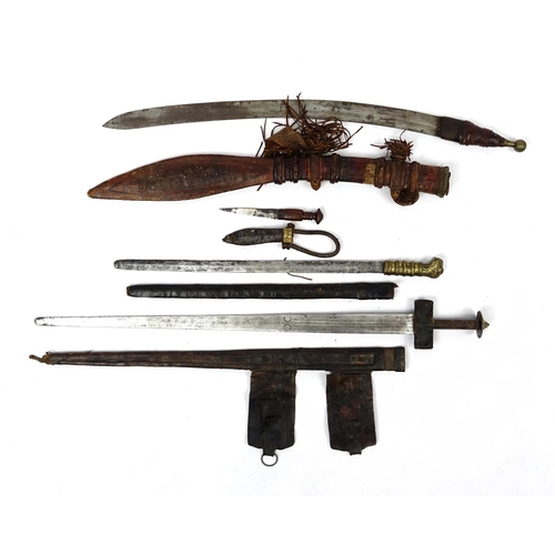 260 - Three Asian and Middle Eastern swords and knifes including a Tuareg, the largest 90cm in length